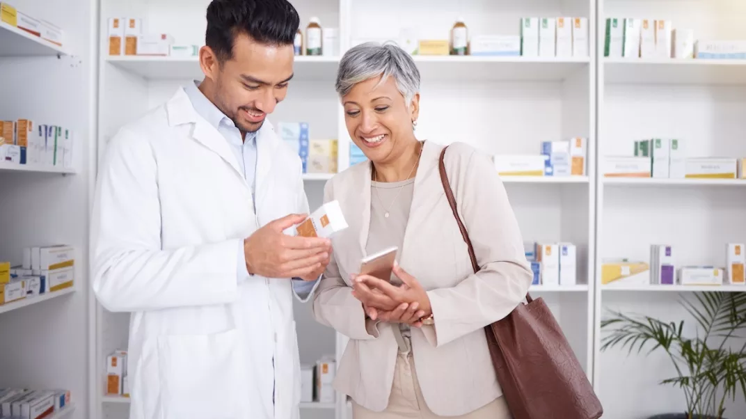 middle aged man smiling looking at phone